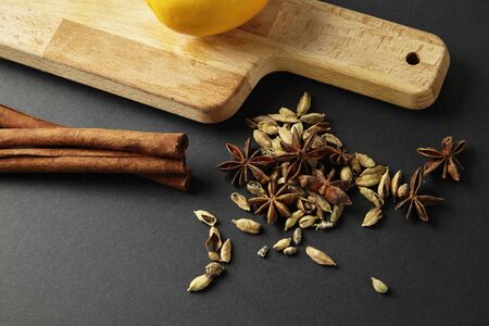 Fresh lemon at cutting board with mixed spice, cinnamon sticksの写真素材