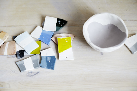Samples of colored enamel for ceramics, ceramic pieces, workshop in studio, hand-craft workの写真素材