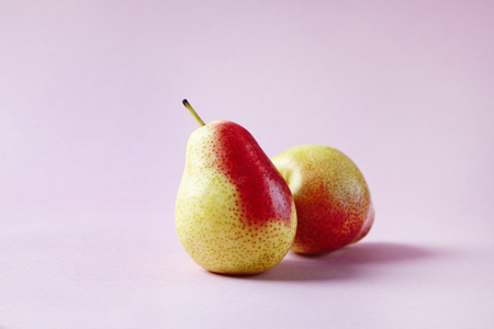 Fresh red pears on hipster pink background, modern style fruit and vegetable food, design layoutの写真素材