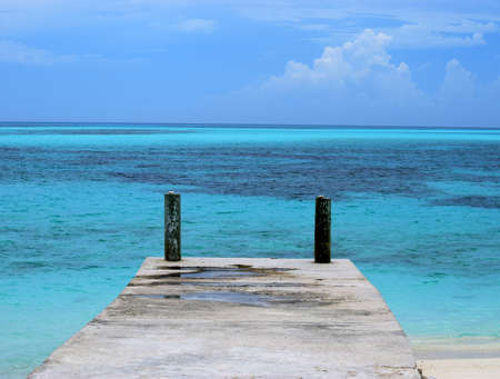 Dock surrounded by aqua blue waters of the Caribbeanの写真素材