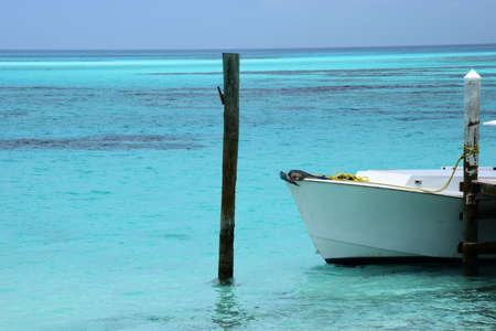 White Boat in Aqua Blue Waters of the Caribbeanの写真素材