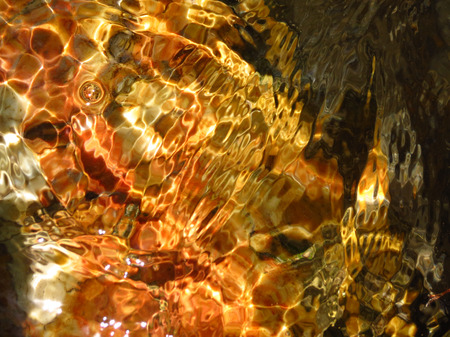 Reflection of water on orange yellow rocksの写真素材