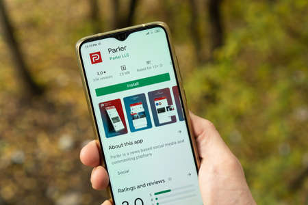 New York - November 2 2020: man holding a smartphone with Parler app on the screen.