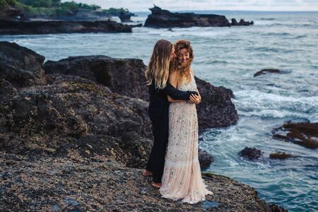 Wedding lovestory, just married couple near the ocean at sunsetの写真素材