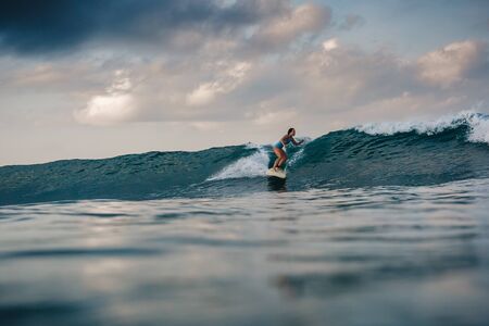Surfer girl on Amazing Blue Wave, Bali island.の写真素材