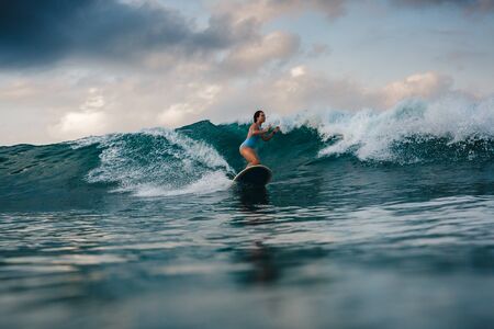 Surfer girl on Amazing Blue Wave, Bali island.の写真素材