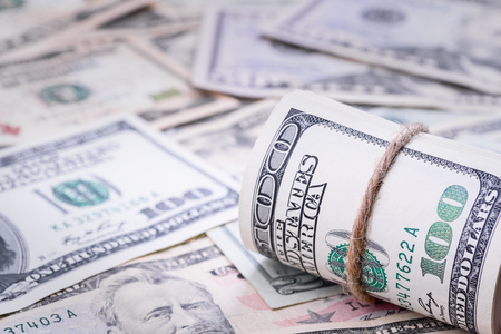 Closeup of rolled American dollar banknotes on the right side. Money background.の写真素材