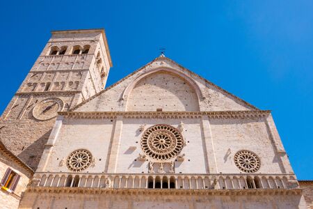 The Cathedral of San Rufino in Assisi, Umbria, Italy, on a sunny summer dayの写真素材