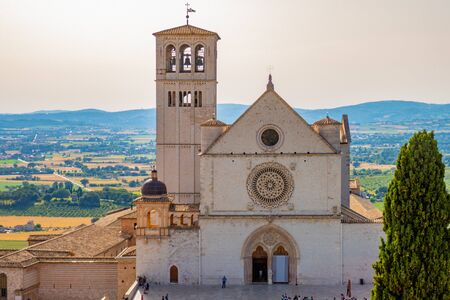 The Basilica of San Francesco in Assisi, Italy, on a summer sunny dayの写真素材