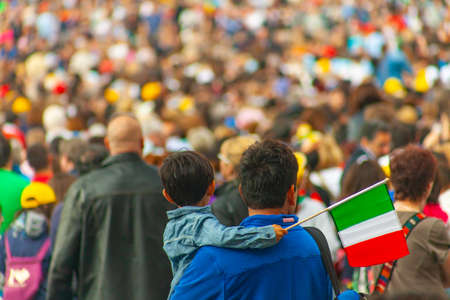 04/09/2014 - Rome, Italy: A man holds his son with a small Italian flag in the crowd