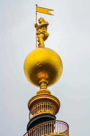 The top of the tower of the Vor Frelsers Kirke, with the characteristic spiral staircase and the golden statue at the topの写真素材