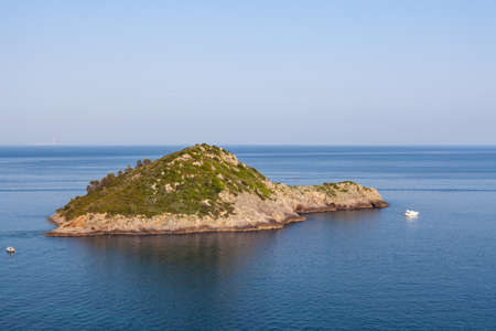 Little island named "L'Isolotto" out of Monte Argentario in Tuscany, Italy, in a sunny clear day with blue skyの写真素材