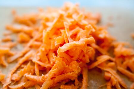 Bunch of grated carrots. Isolated on a white background.の写真素材