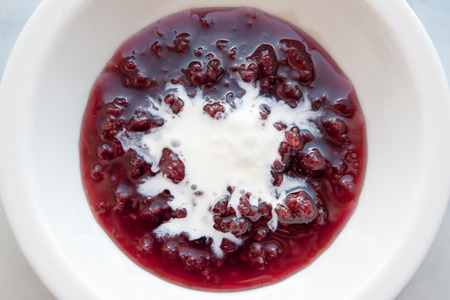 raspberry jam glass  isolated on a white backgroundの写真素材