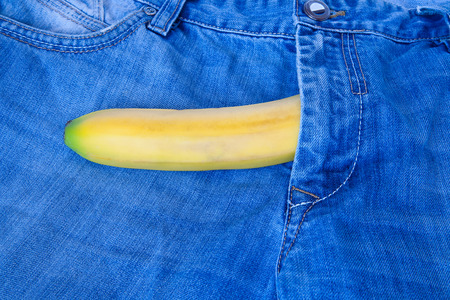 Safe sex concept. Blue jeans and banana with condom , condom banana denimの写真素材