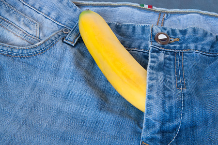 Safe sex concept. Blue jeans and banana with condom , condom banana denimの写真素材