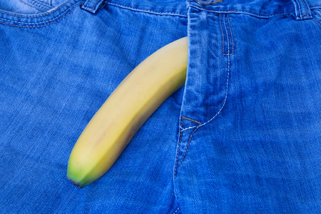 Safe sex concept. Blue jeans and banana with condom , condom banana denimの写真素材