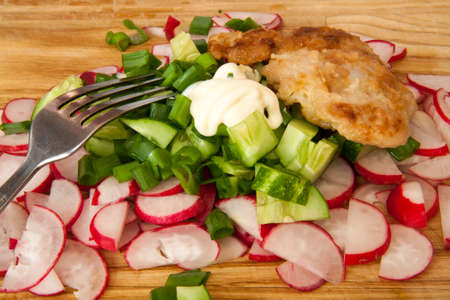 radishes olives and green cucumber on a plateの写真素材