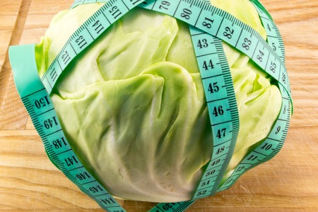 fresh cabbage wrapped meter on the boardの写真素材