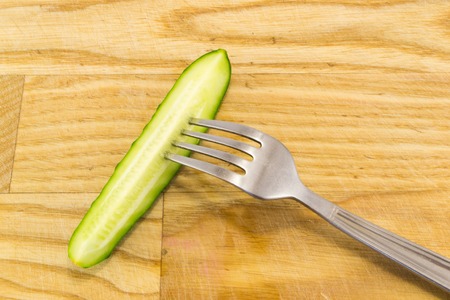 cucumber with tape measure isolated on white backgroundの写真素材