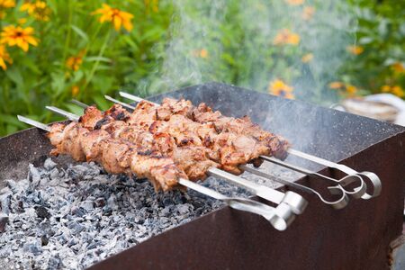 Juicy slices of meat with sauce prepare on fire .shish kebabの写真素材