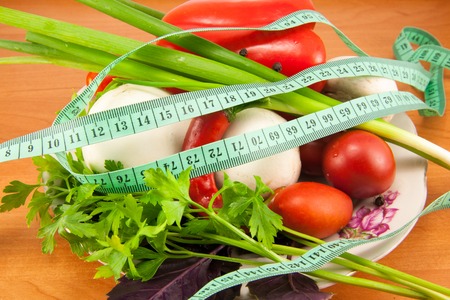 Mixed fresh vegetables on the plate on the boardの写真素材