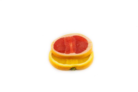 cutting grapefruit and orange isolated on white backgroundの写真素材