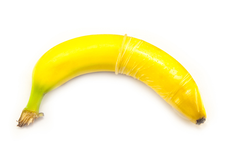 banana with condom isolated on white. stock image.の写真素材