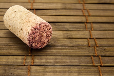 Close-up of vintage wine cork on old wooden surface.の写真素材