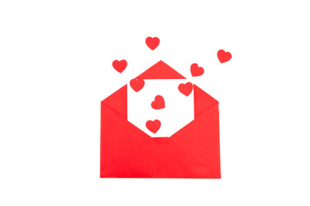 Red envelope with a white sheet of paper and red hearts on a white background. Valentine's day greeting card. isolate.の写真素材