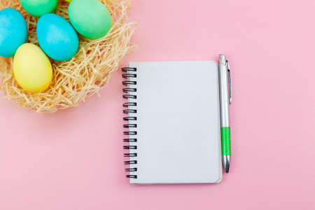 Blank notepad and pen on trendy dark pink background. Notebook for ideas message, list and...