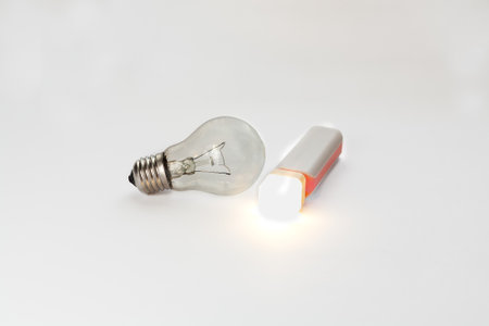 LED flashlight from Power Bank via USB and incandescent lamp. Comparison of energy saving and...