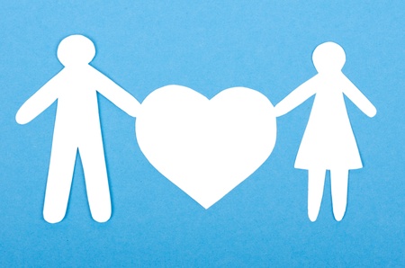 Closeup of paper people with a big heart on white backgroundの写真素材