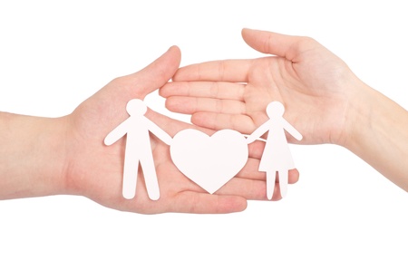 Paper family in hand with a big heart isolated on whiteの写真素材