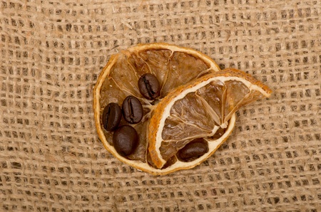 lemons and coffee beans on burlapの写真素材