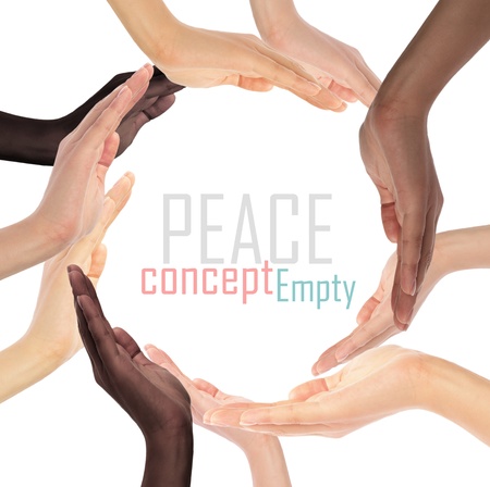 Conceptual symbol of multiracial human hands making a circle on white background with a copy space in the middleの写真素材