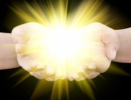 Holding hands open with glowing lightsの写真素材