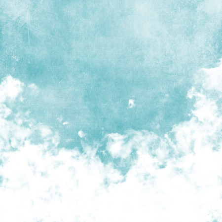 Sky, fog, and clouds on a textured, vintage paper background with grunge stainsの写真素材