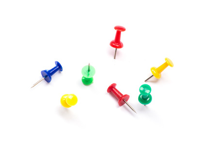 Set of push pins in different colors, with real shadows, isolated on white background.