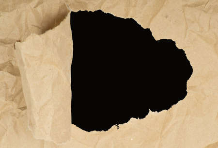 ripped white paper against a black backgroundの写真素材