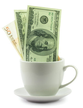 Money in a cup isolated on a white backgroundの写真素材