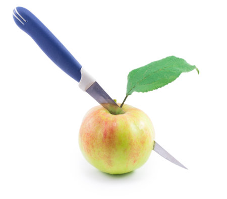 an apple with a knife isolated on white backgroundの写真素材