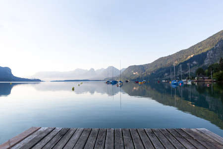 Sunrise over the lake Wolfgangsee in the Austrian Alps. View from a wooden bridgeの写真素材