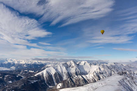 Hot air ballooning in the Alps. Winter adventure concept