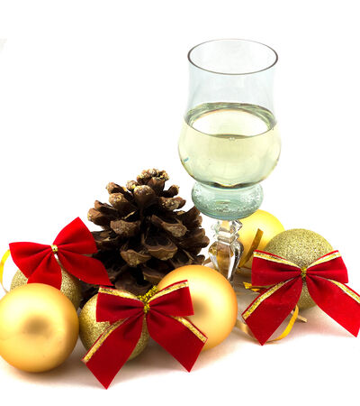 glass of champagne with Christmas decorations on a white backgroundの写真素材