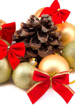 Christmas golden balls with red ribbons on a white backgroundの写真素材