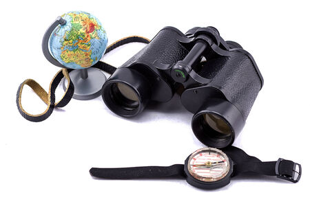 large binoculars, globe and compass on a white backgroundの写真素材