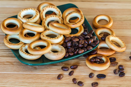 ruddy bagels and coffee beans on a plateの写真素材