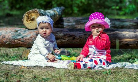 two little girls playing on the meadowの写真素材