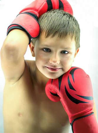 Portrait of a boy in red boxing glovesの写真素材